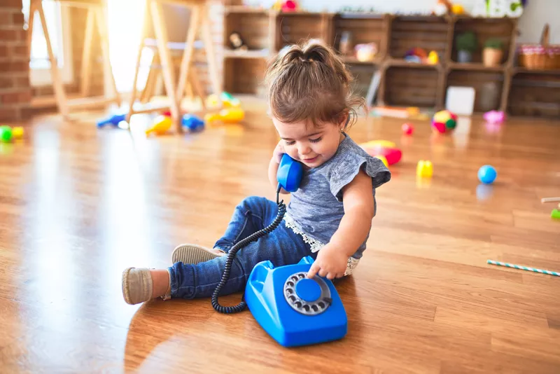 Girl playing on an old-fashioned telephone
