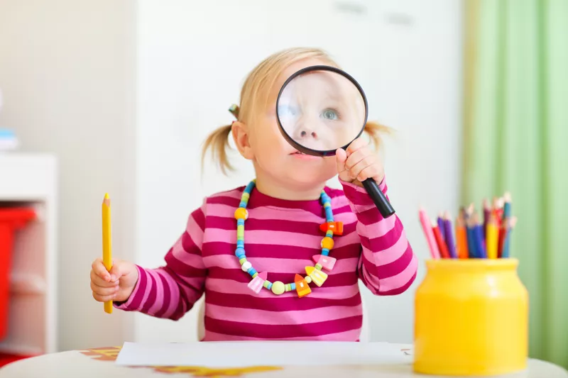 Girl with magnifying glass